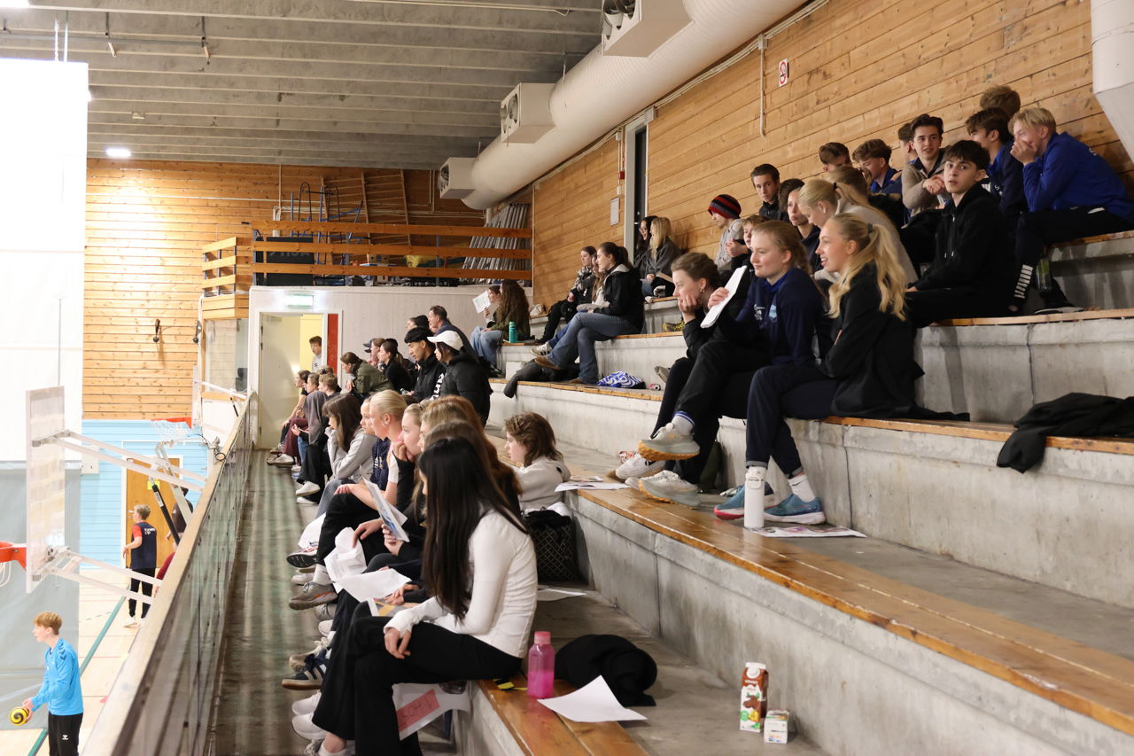 Foto av elever på tribunen i idrettshallen